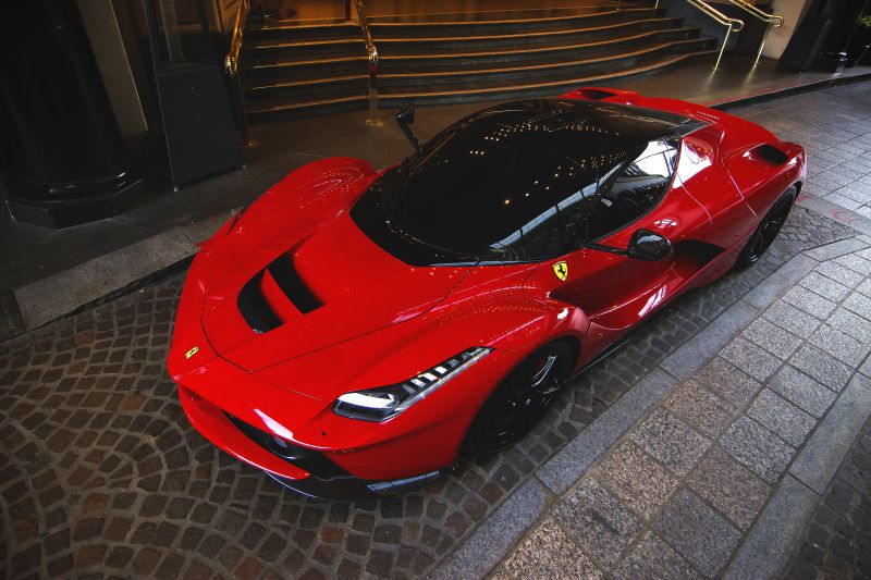 Front view of red supercar with aerodynamic design and sharp headlights