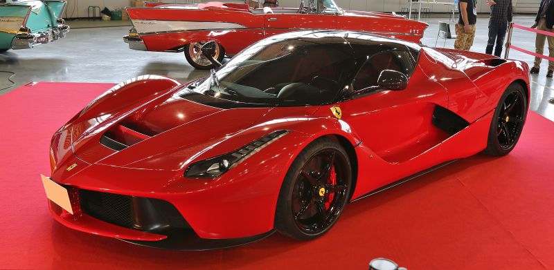 Red hypercar with sleek aerodynamic body and scissor doors