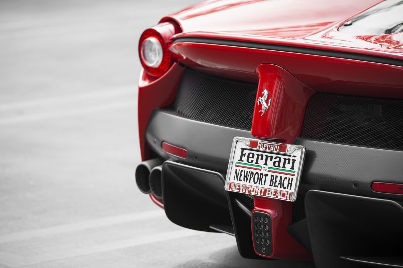 Close-up of rear exhaust pipes, diffuser, and tail light