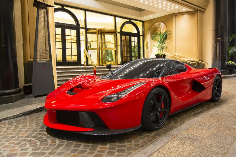 Red hypercar with aerodynamic body and black alloy wheels