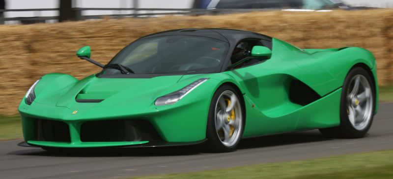 Aerodynamic green sports coupe with black roof and side air vents