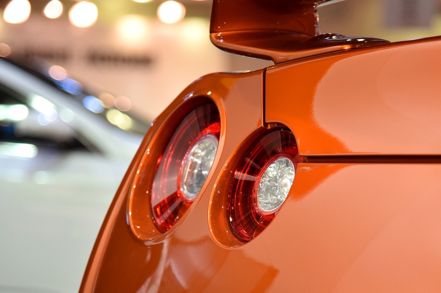 Close-up of rear dual round LED taillights and spoiler