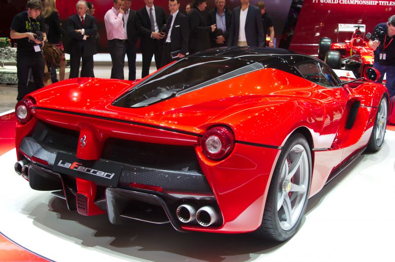 Red supercar rear with quad exhausts and aerodynamic design