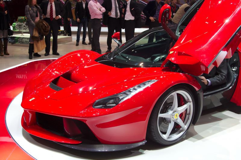 Red supercar front with butterfly door open