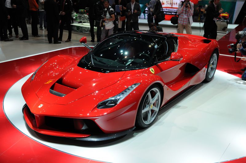 Sleek aerodynamic red sports car with aggressive front design.