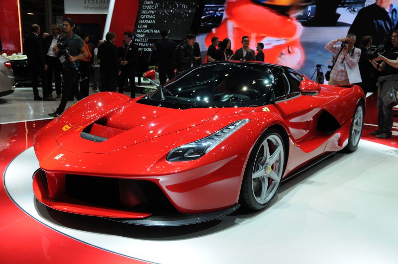Red exotic sports car with aerodynamic design and sleek headlights