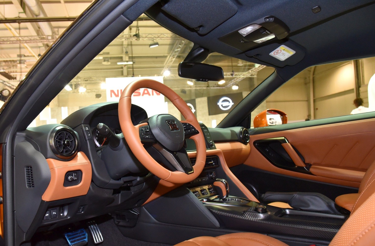 Sports car interior with leather-wrapped steering wheel and dashboard