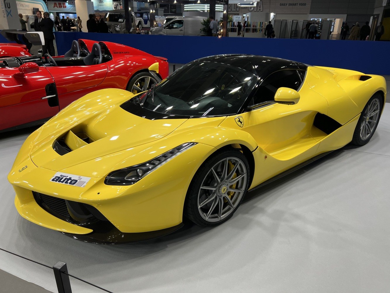Yellow high-performance sports car with aerodynamic body and signature wheels