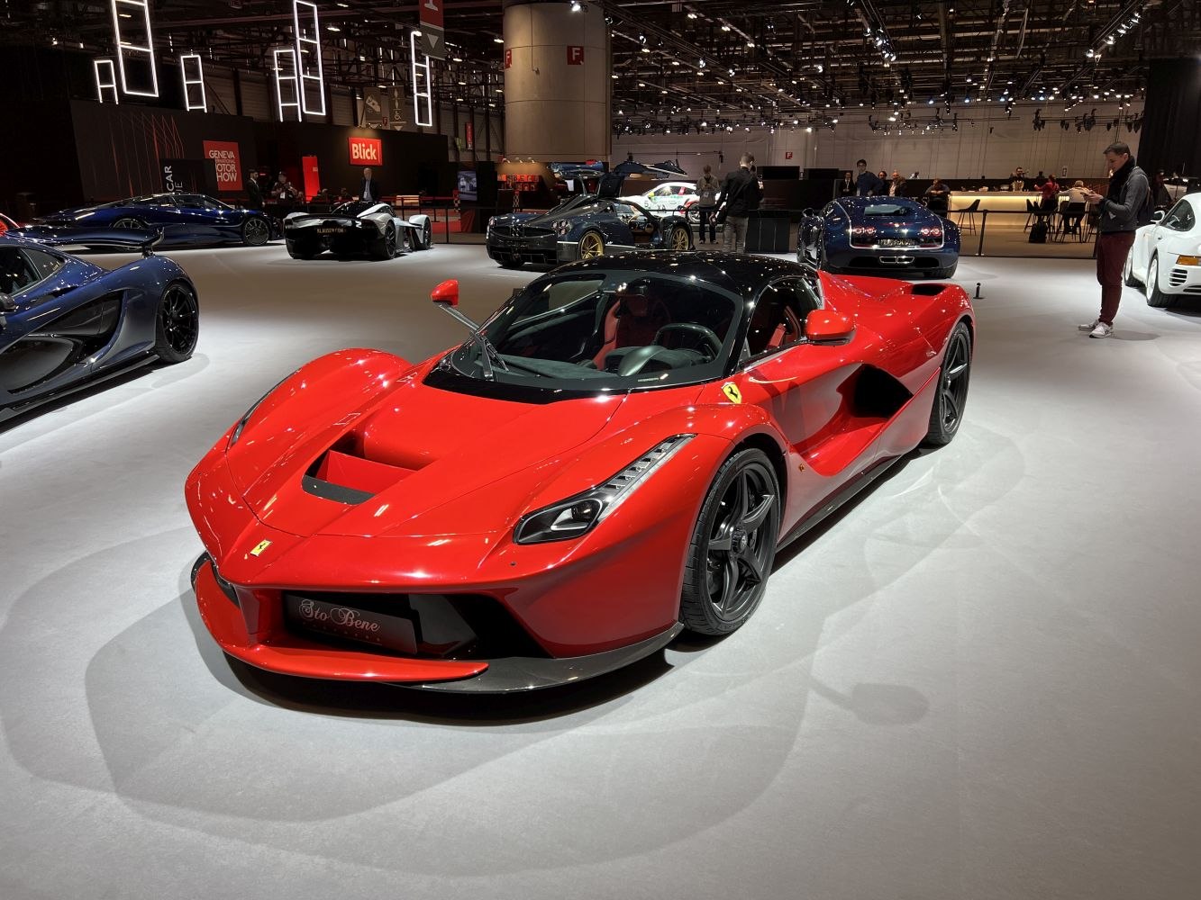 Red sports coupe with aerodynamic design and black roof