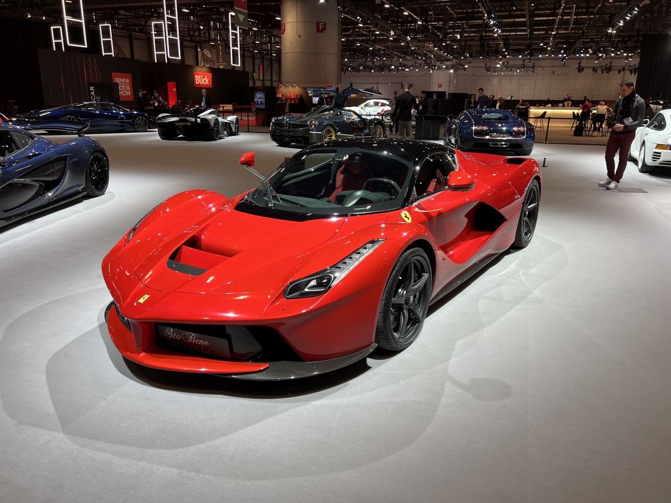 Red sports car with black roof and aerodynamic curves