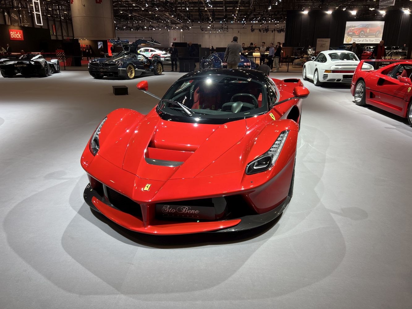 Front view of a red sports car with aggressive headlights and aerodynamic features