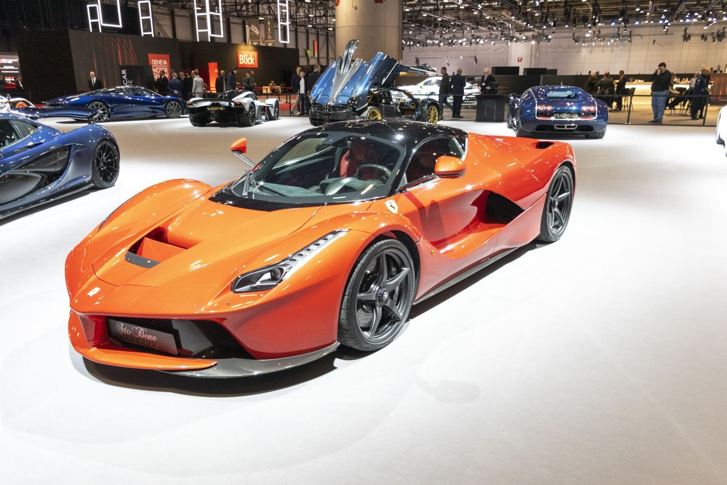 Orange sports car with aerodynamic shape and black roof