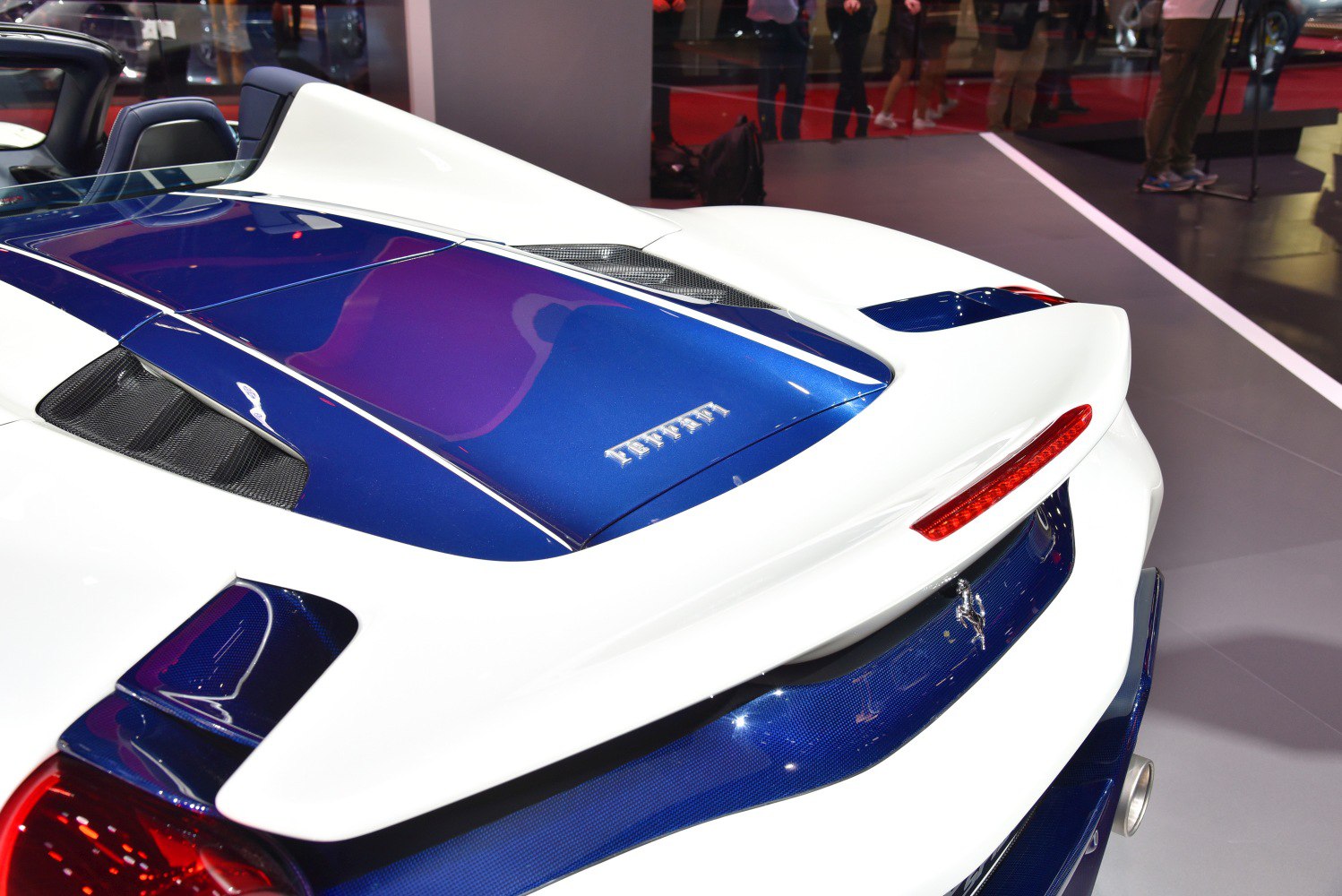 Rear section with engine cover and aerodynamic spoiler in white and blue.