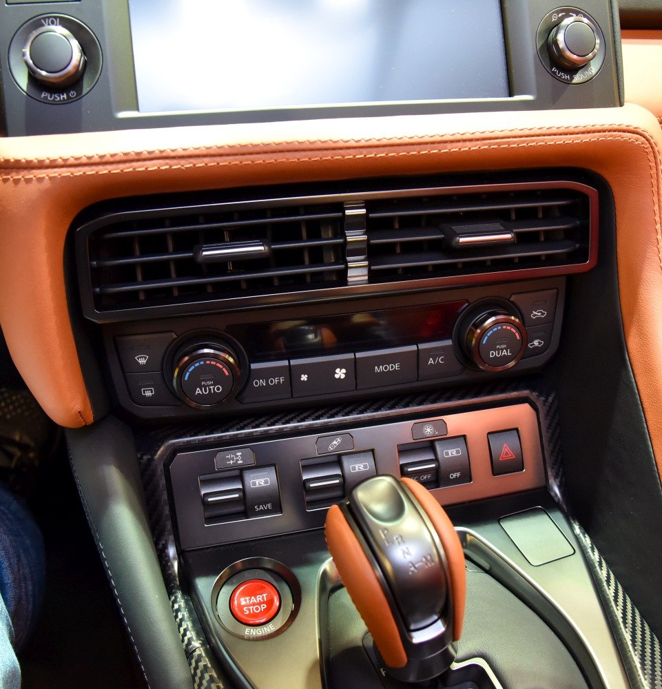 Close-up of car interior control panel and gear shifter with start/stop button