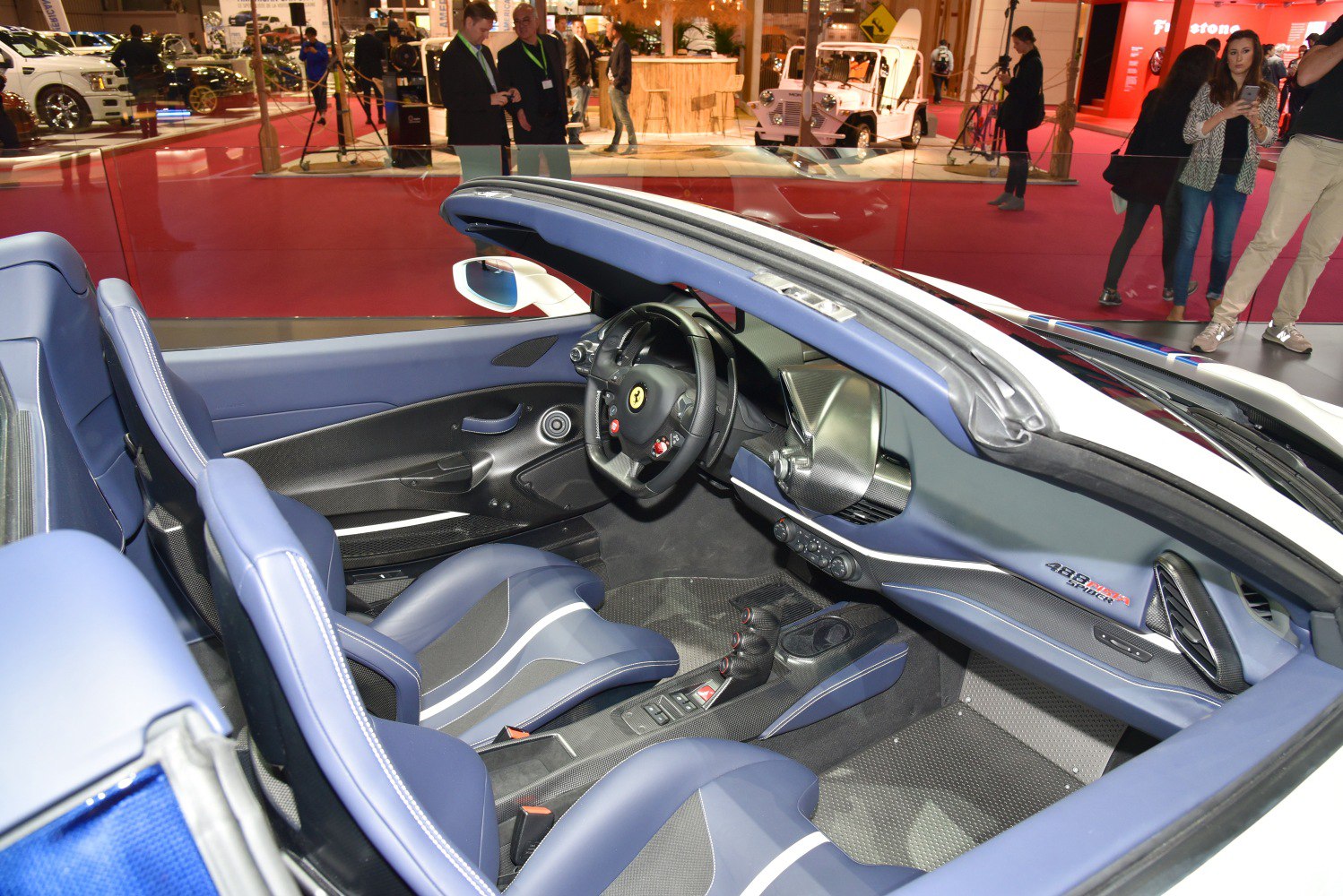 Blue leather racing seats and carbon fiber trim in sportscar convertible interior