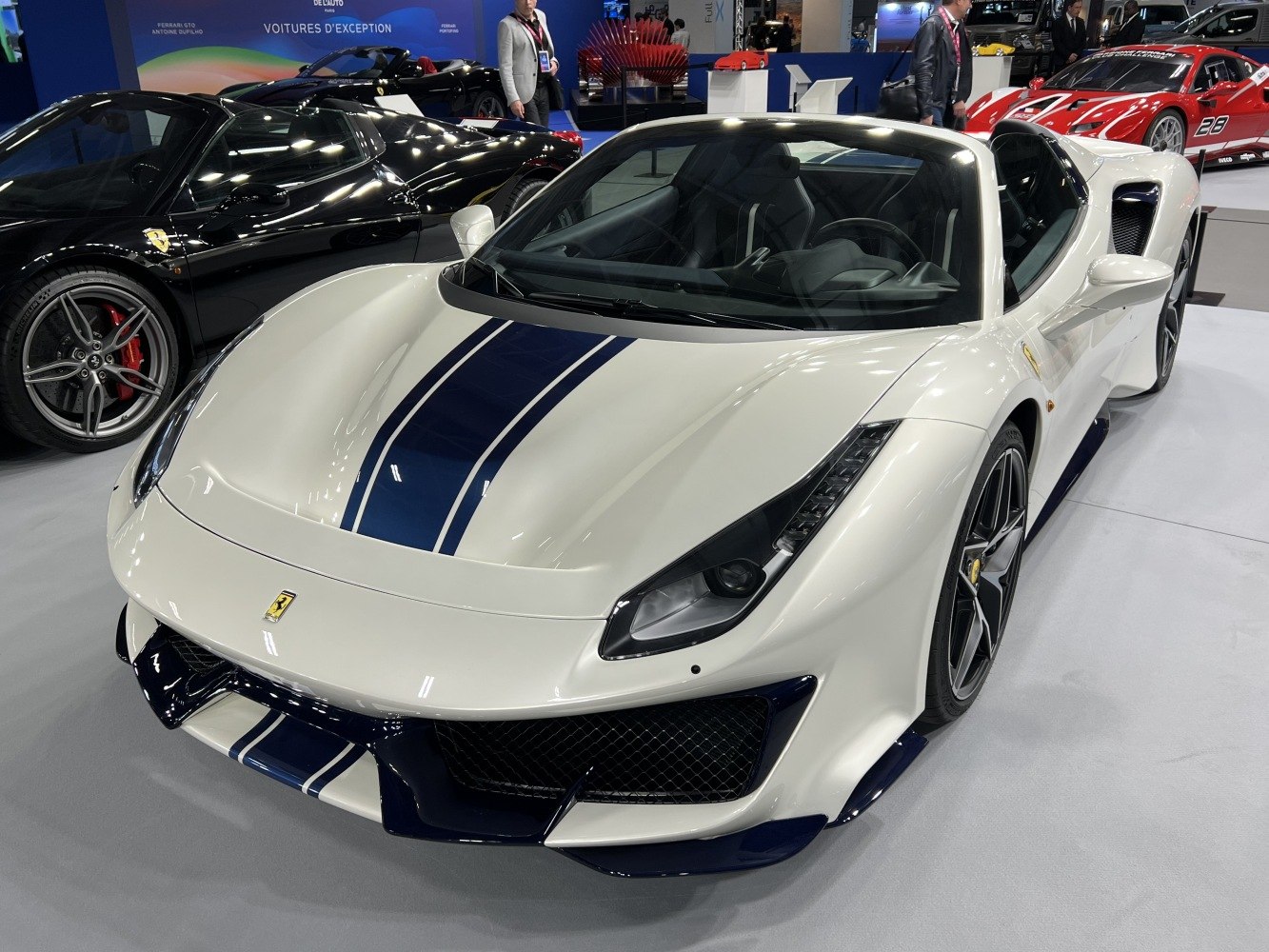 Front close-up of a convertible sports car with racing stripes