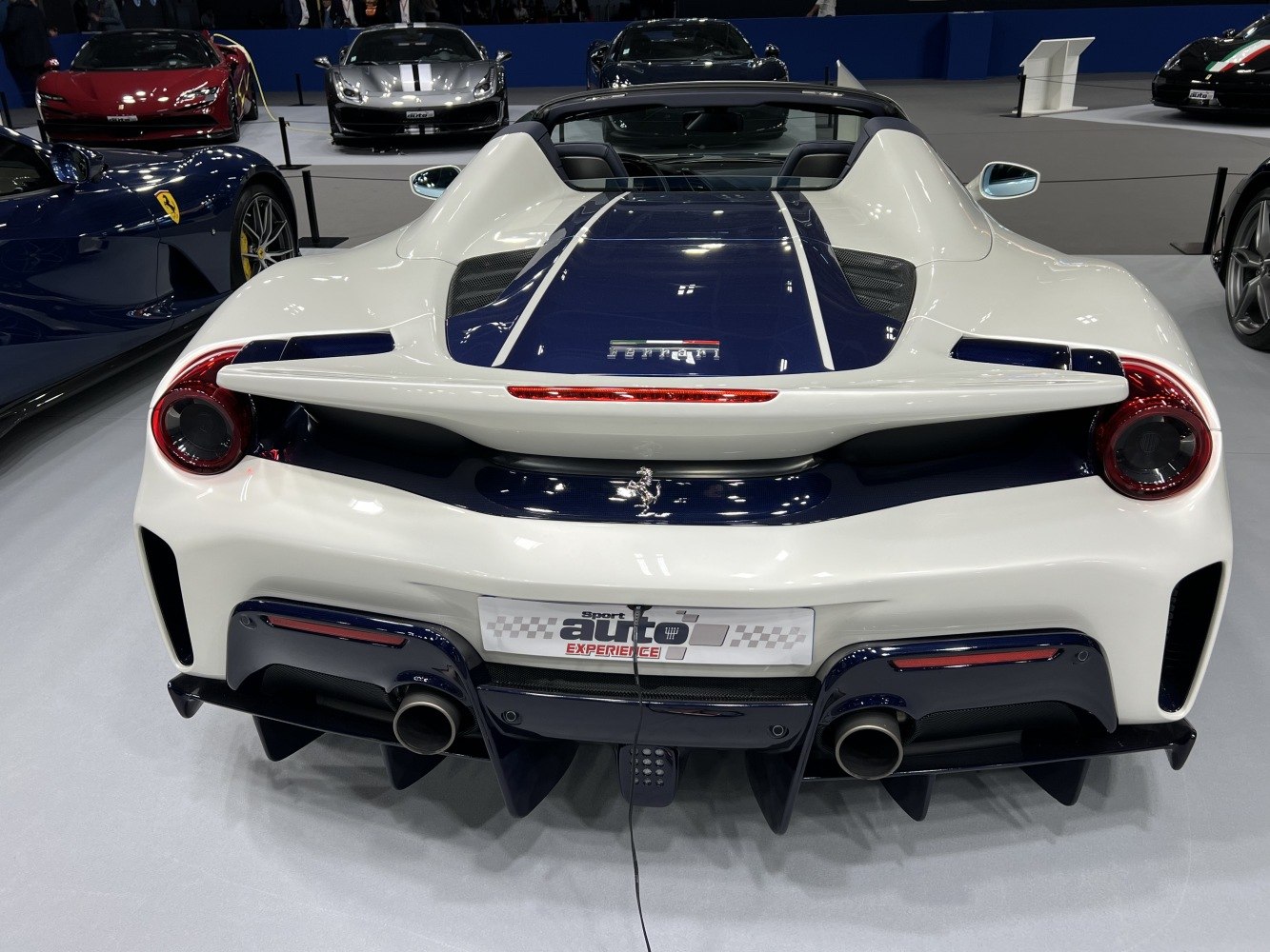 Dual round tail lights, rear spoiler, and aerodynamic diffuser on sports car rear