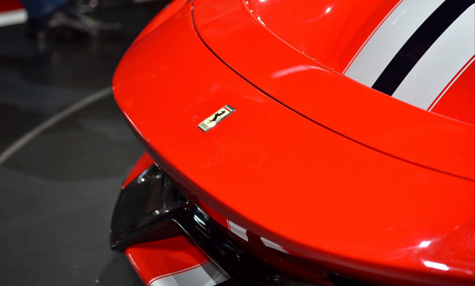 Rear spoiler with badge and racing stripes on red paint