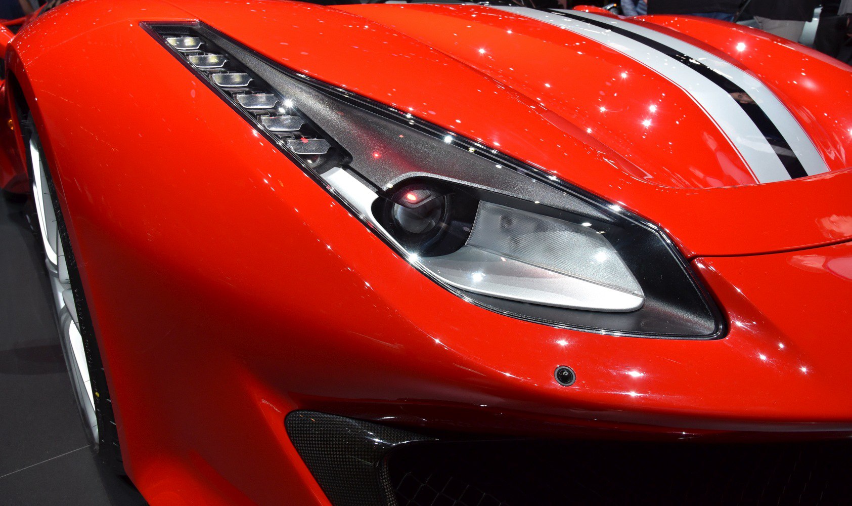 Close-up of aerodynamic front with LED headlight and racing stripe