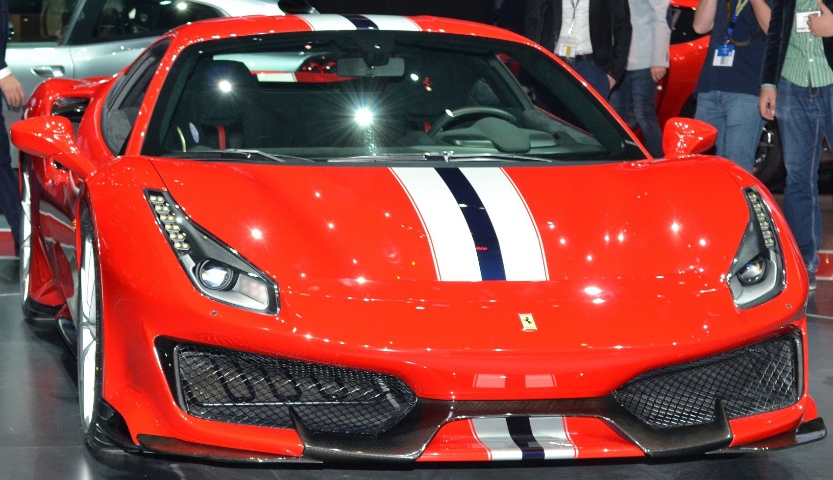 Red sports car front with racing stripes and aerodynamic features