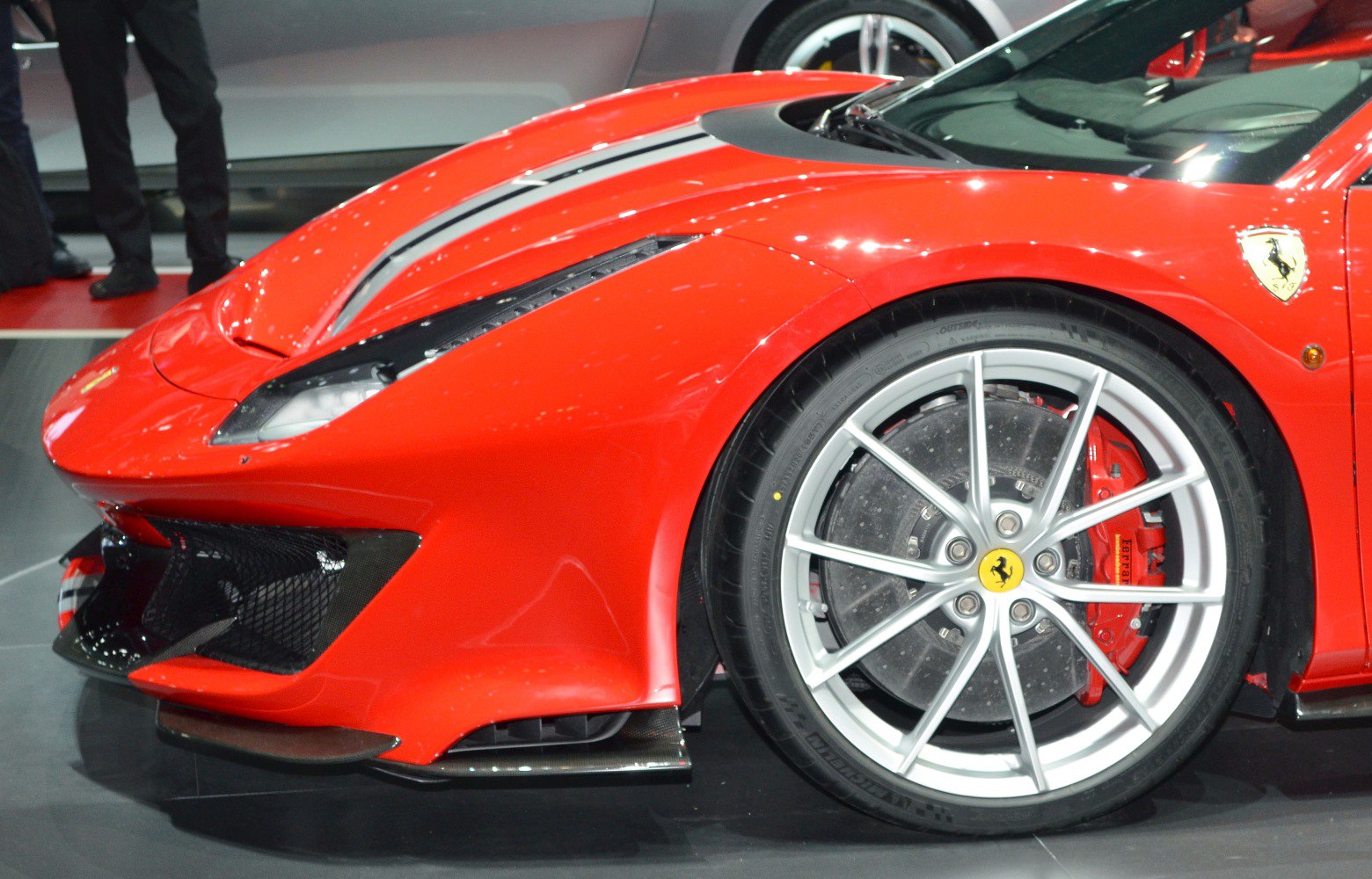 Front fender, alloy wheel, and aerodynamic elements of a sports car.