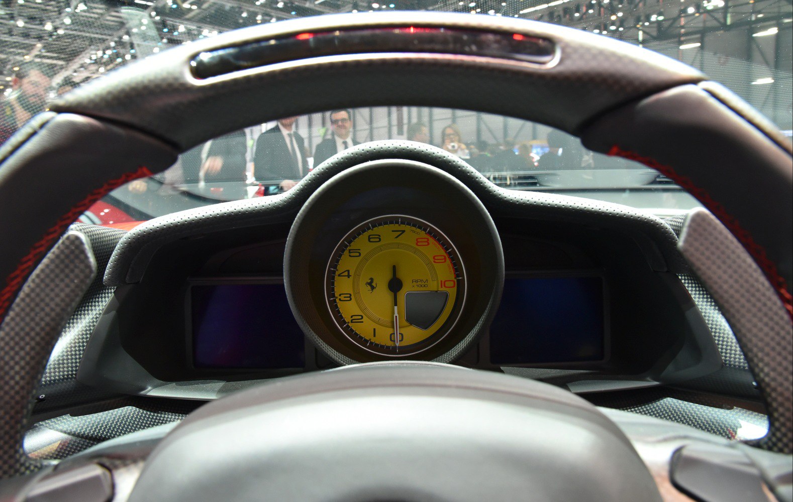 Steering wheel and yellow tachometer dial in the car interior