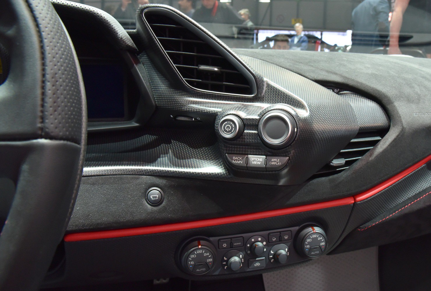 Carbon fiber dashboard with advanced climate controls and Apple CarPlay buttons
