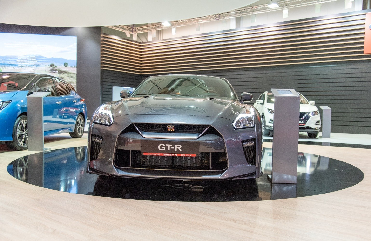 Aggressive front grille and distinct headlights on sports car in showroom