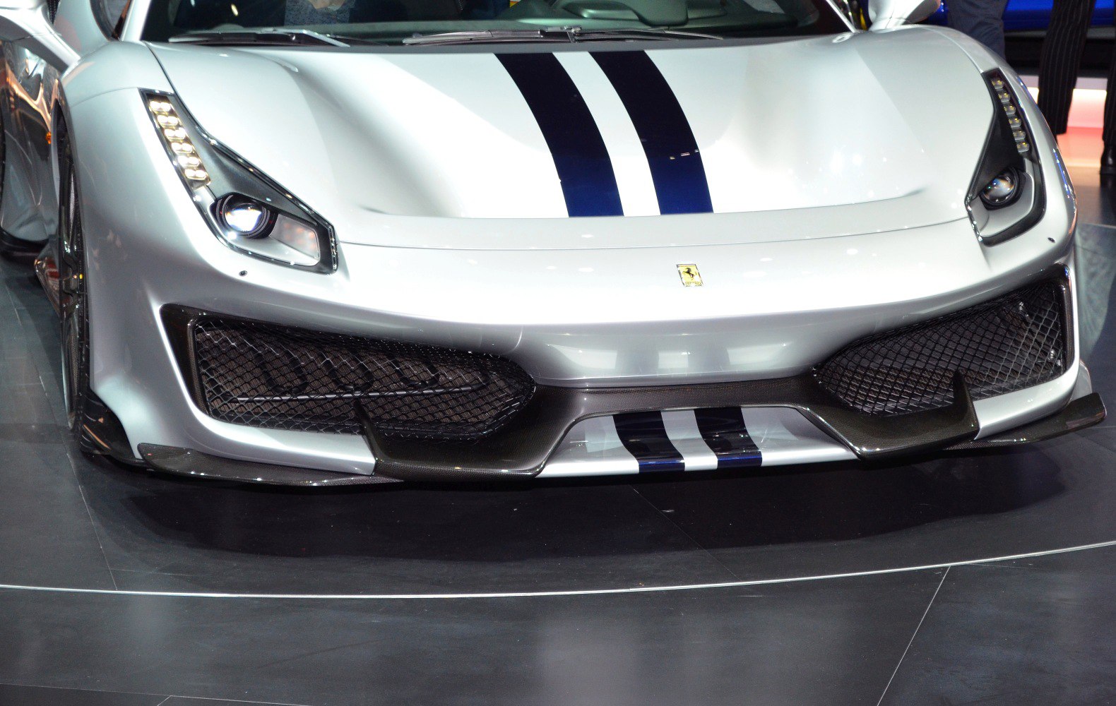 Close-up of front fascia with LED headlights and racing stripes