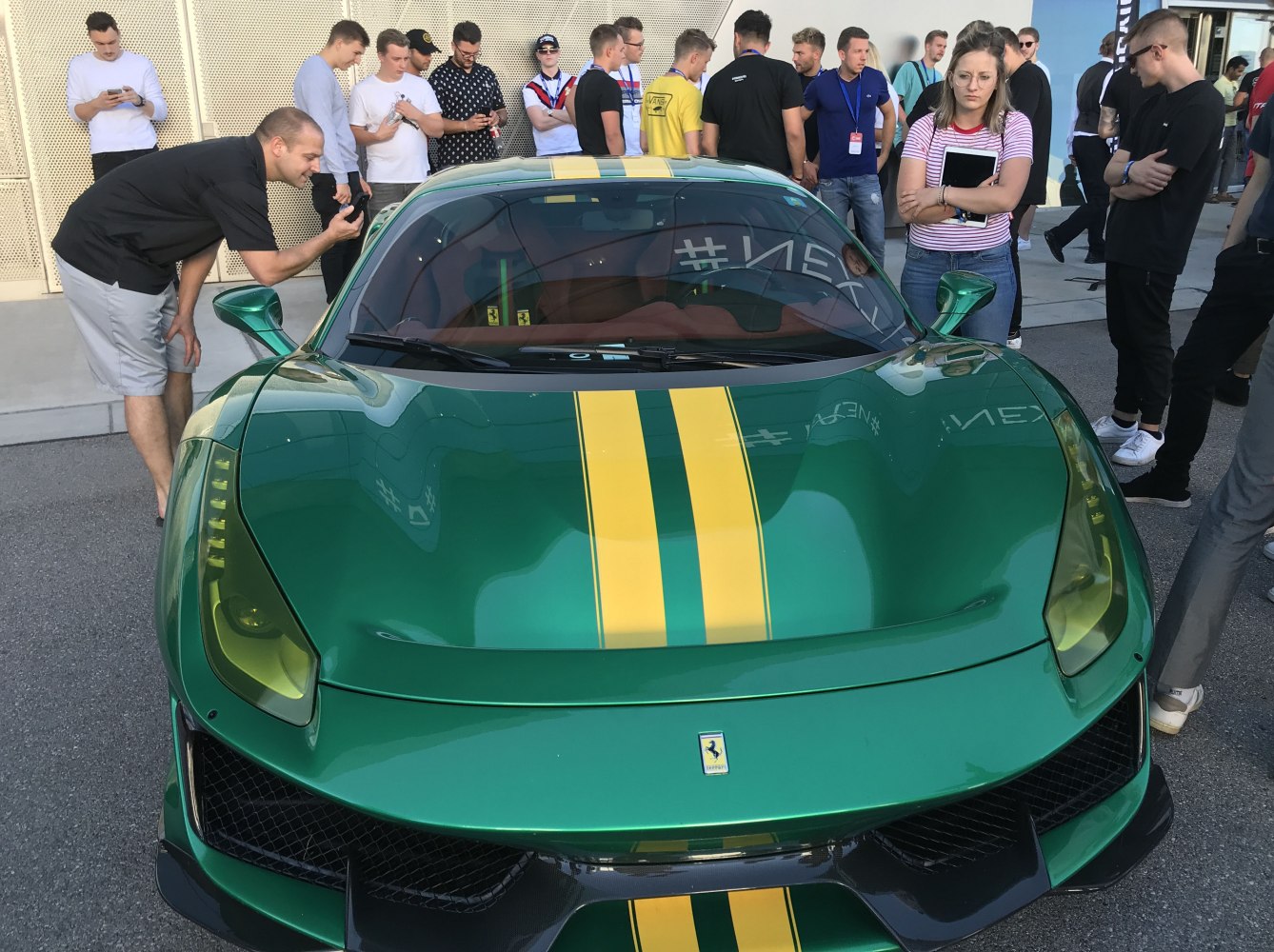 Front view of green Ferrari with yellow racing stripe