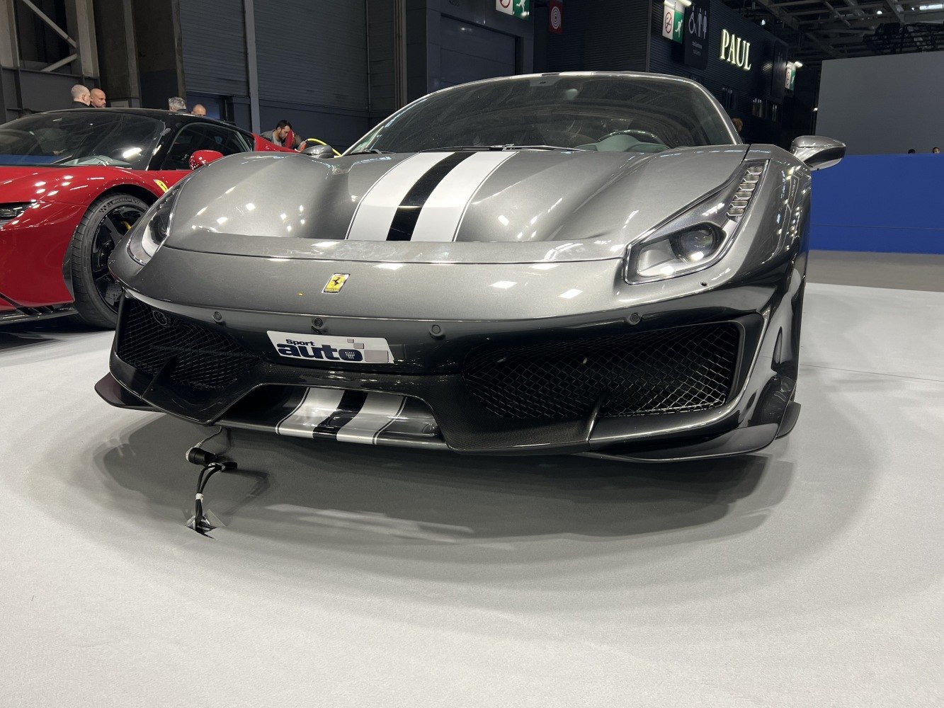 Front view with black and white racing stripe and aggressive aerodynamic splitter.