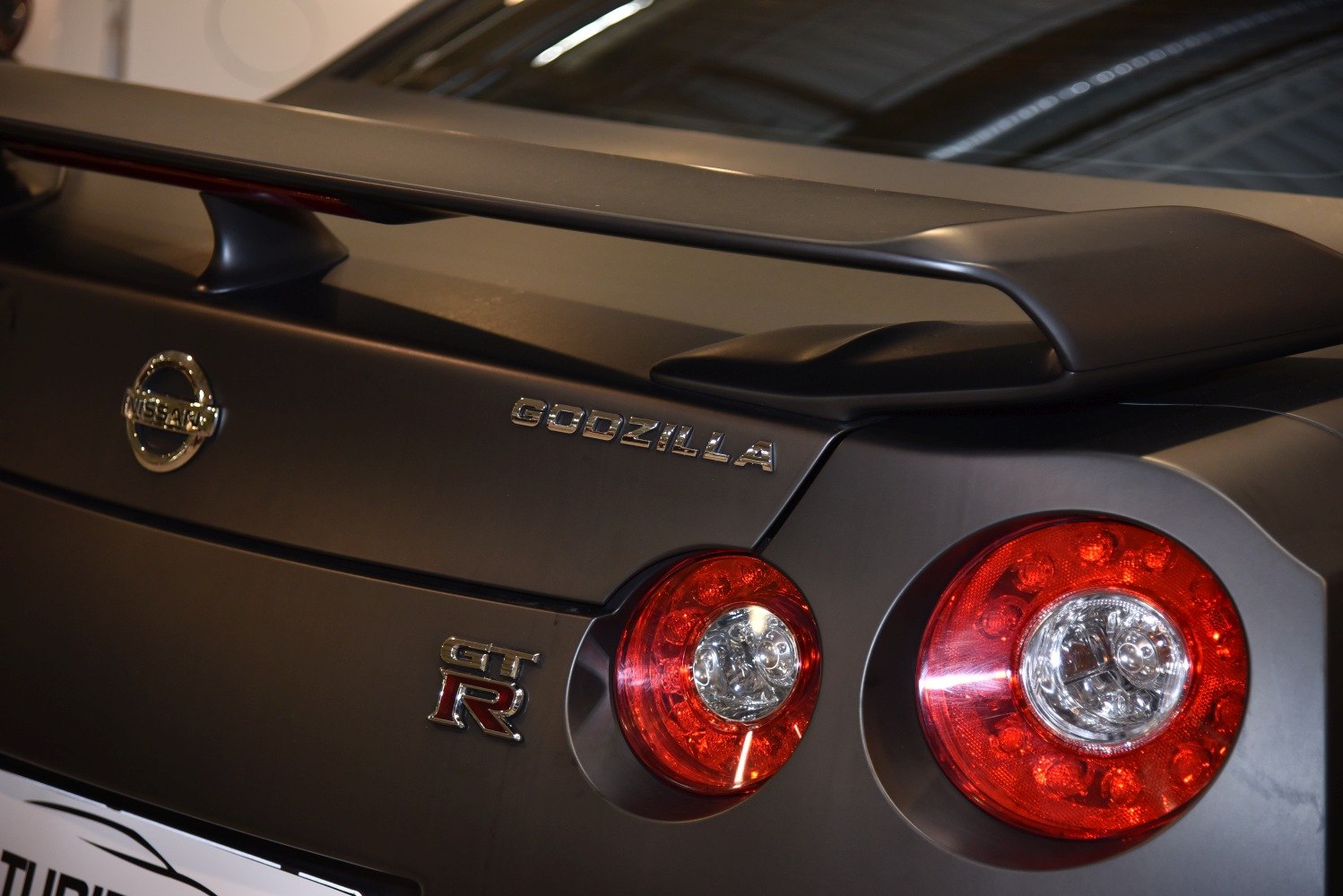 Rear spoiler with round tail lights and Godzilla badge