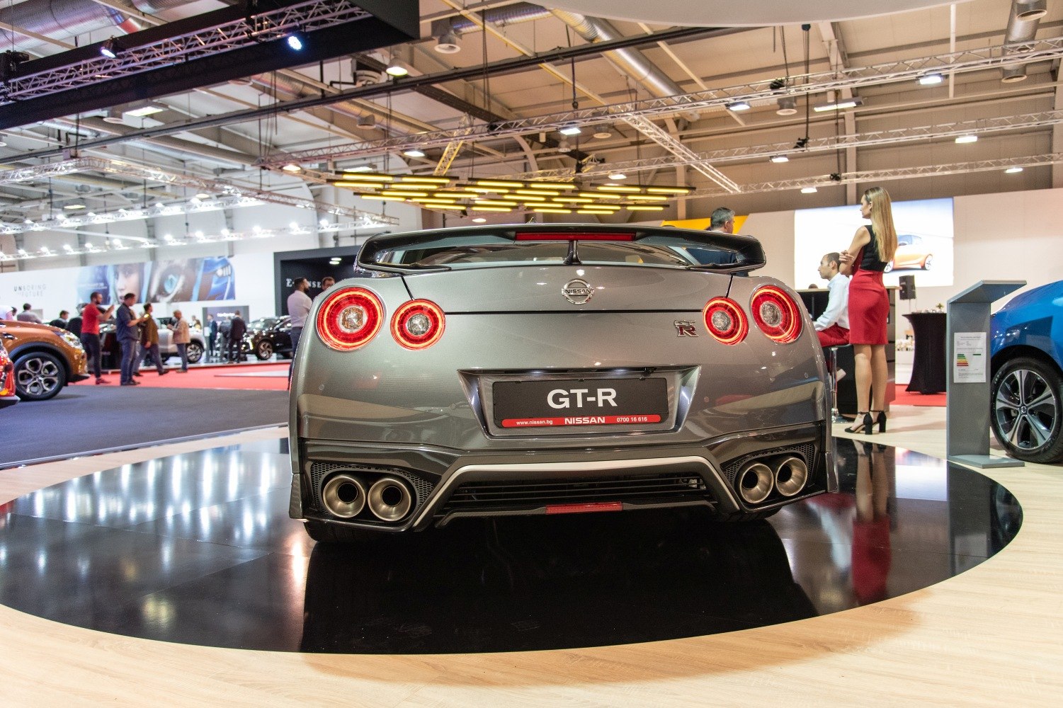 Rear view with quad exhausts, round taillights, and rear spoiler