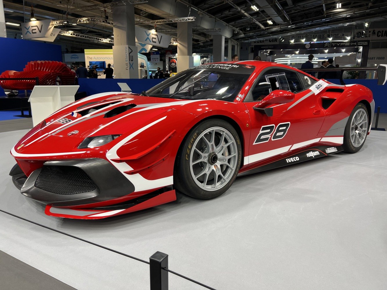 Red racing sports car with aerodynamic body and number 28