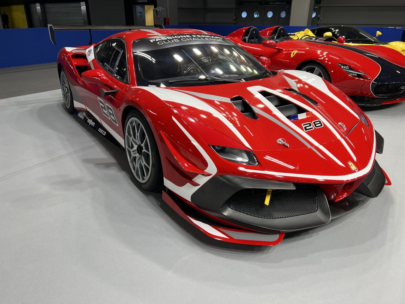 Aerodynamic race car front with vents and bold red-white livery
