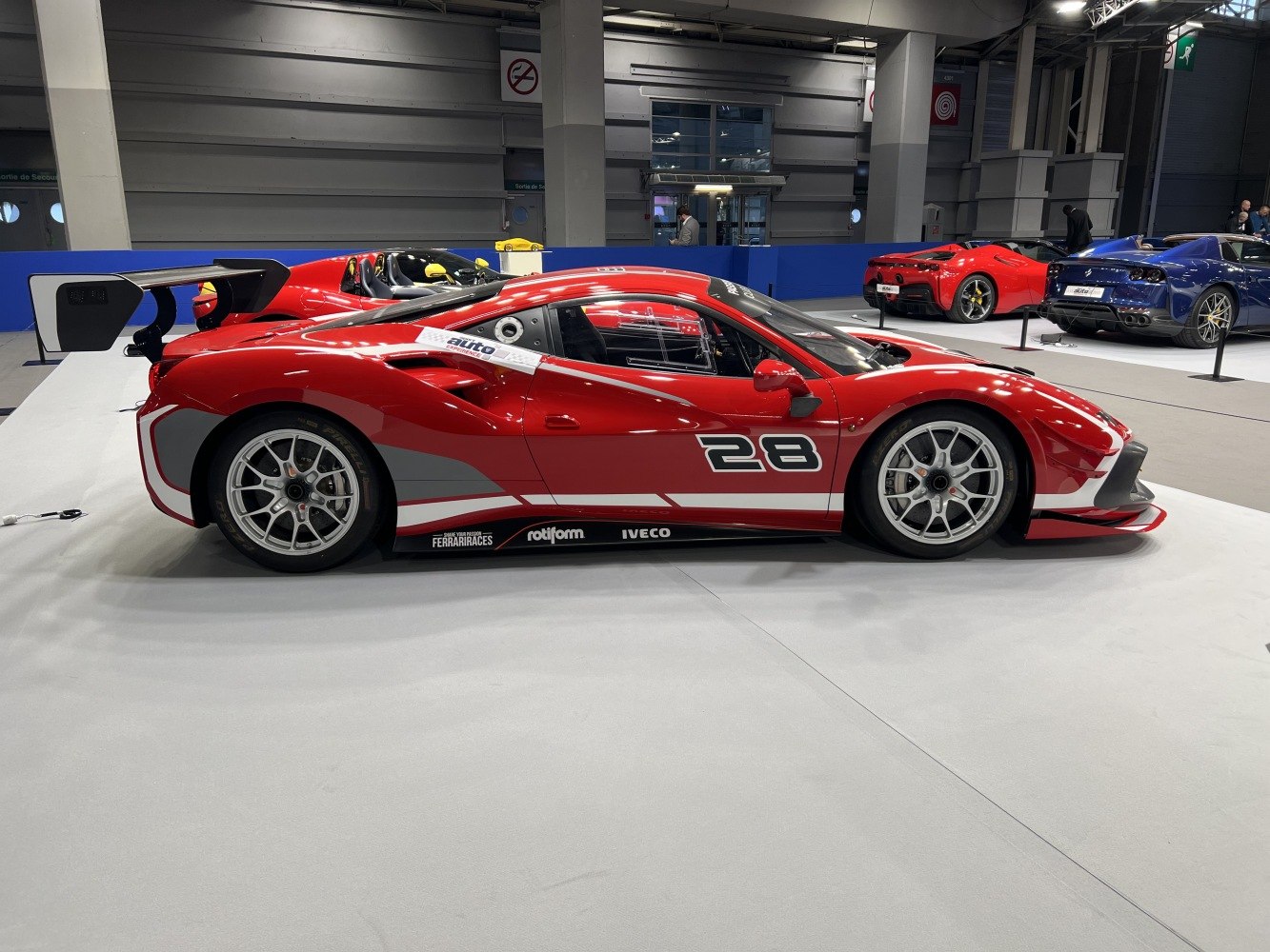 Side profile of a race car with large rear wing and racing decals