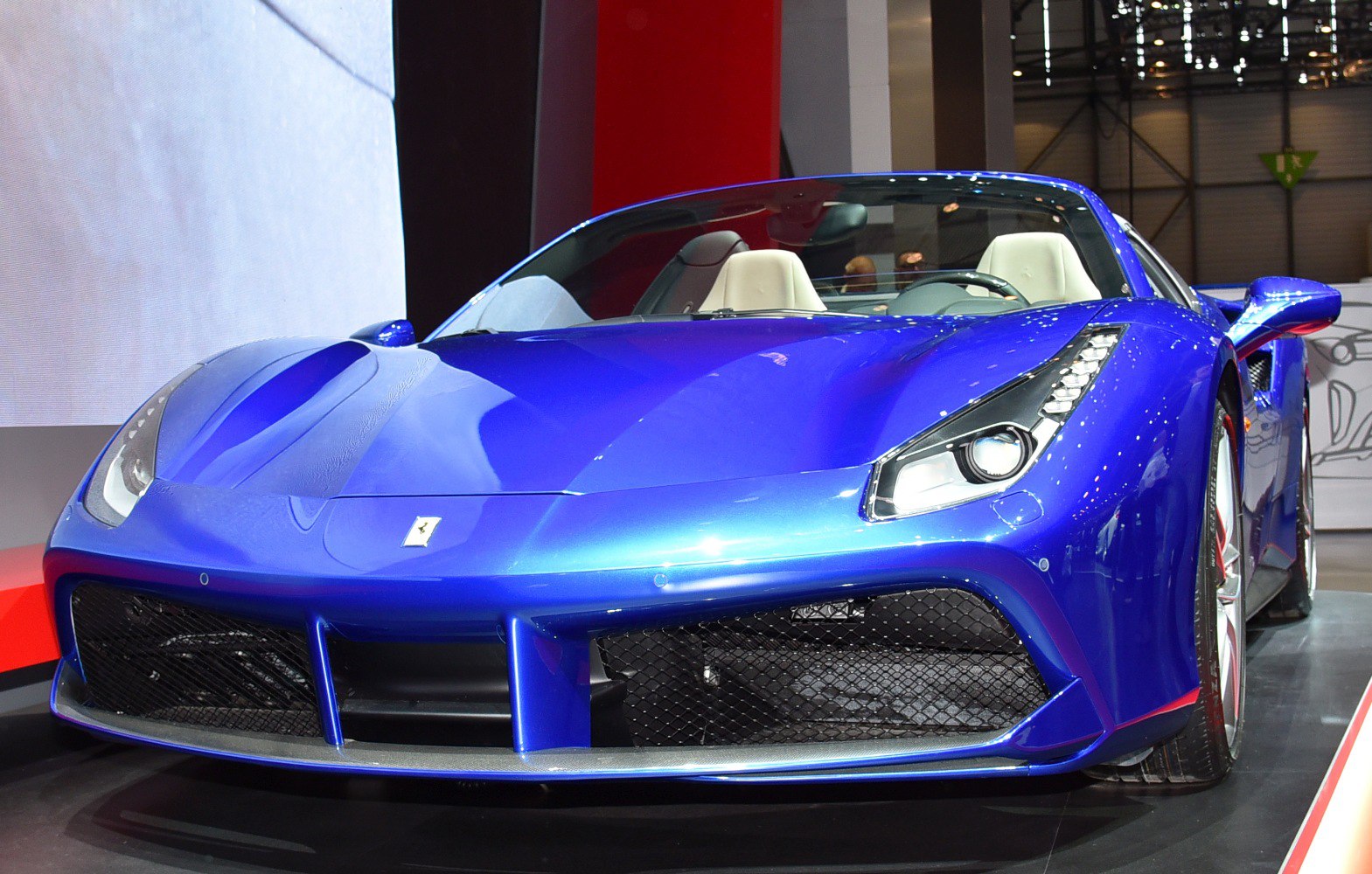 Blue luxury convertible front fascia with LED headlights and aggressive grille