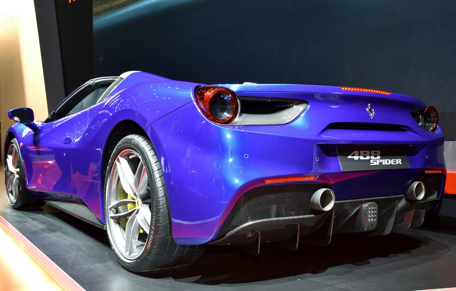Rear view of blue sports convertible with dual exhaust and alloy wheels