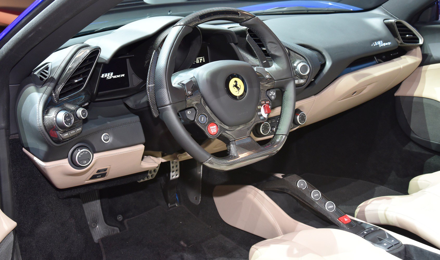 Luxury sports car interior with carbon fiber dashboard and steering wheel