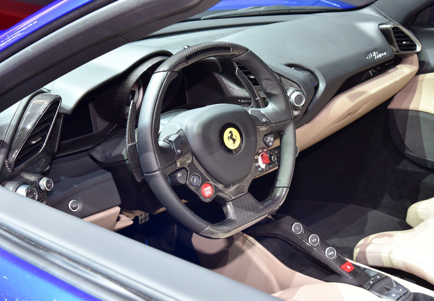 Carbon fiber steering wheel and luxury sports car interior.