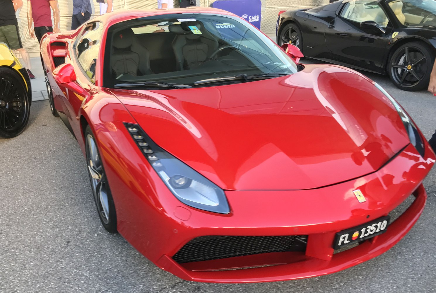 Front view of red sports car with aerodynamic lines and distinctive headlights