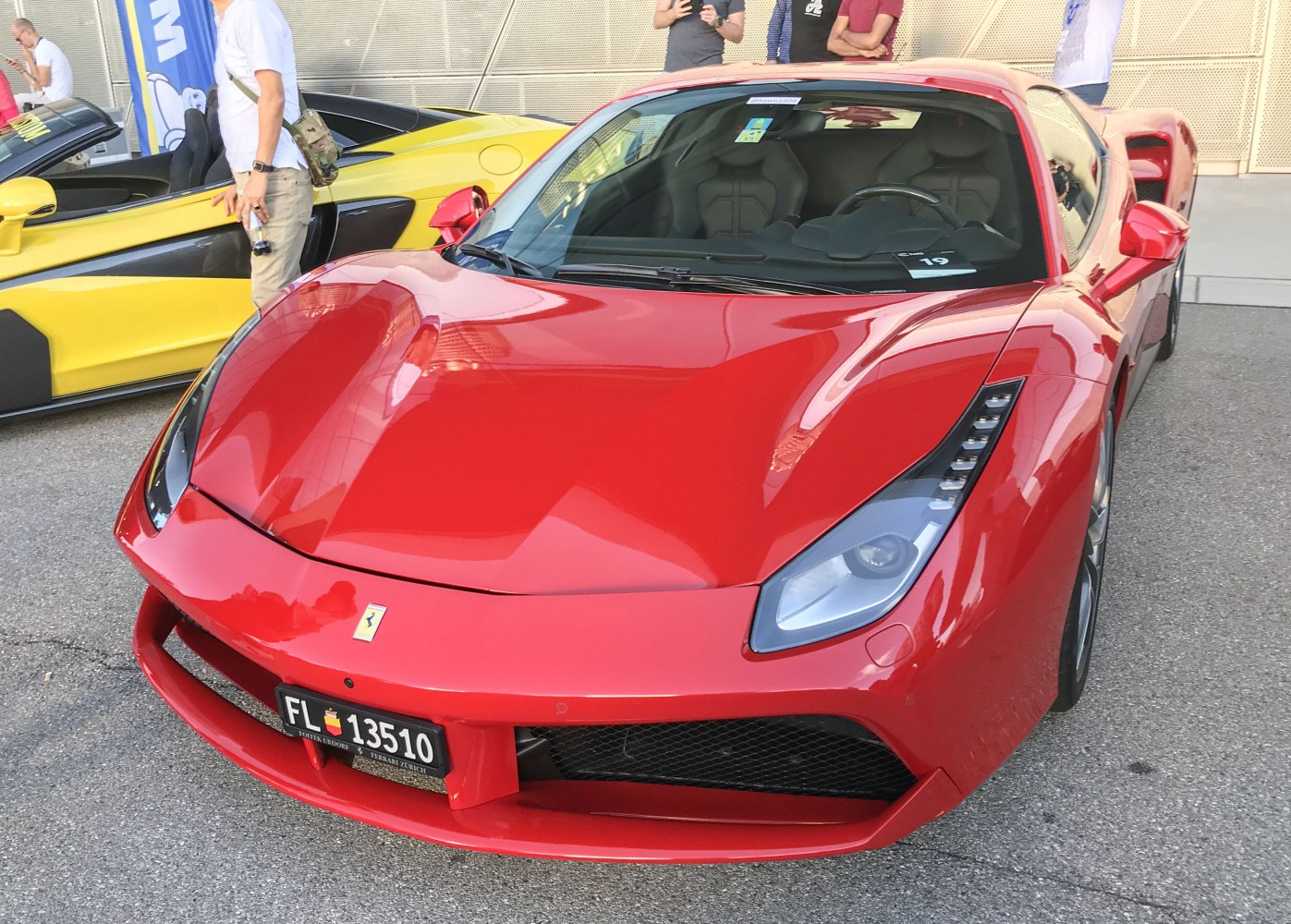 Close-up of sleek red supercar front with aerodynamic bumper and LED headlights