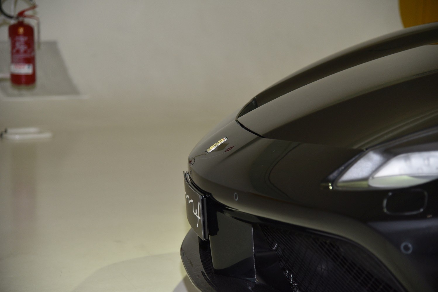 Front nose with headlight and air intake close-up.