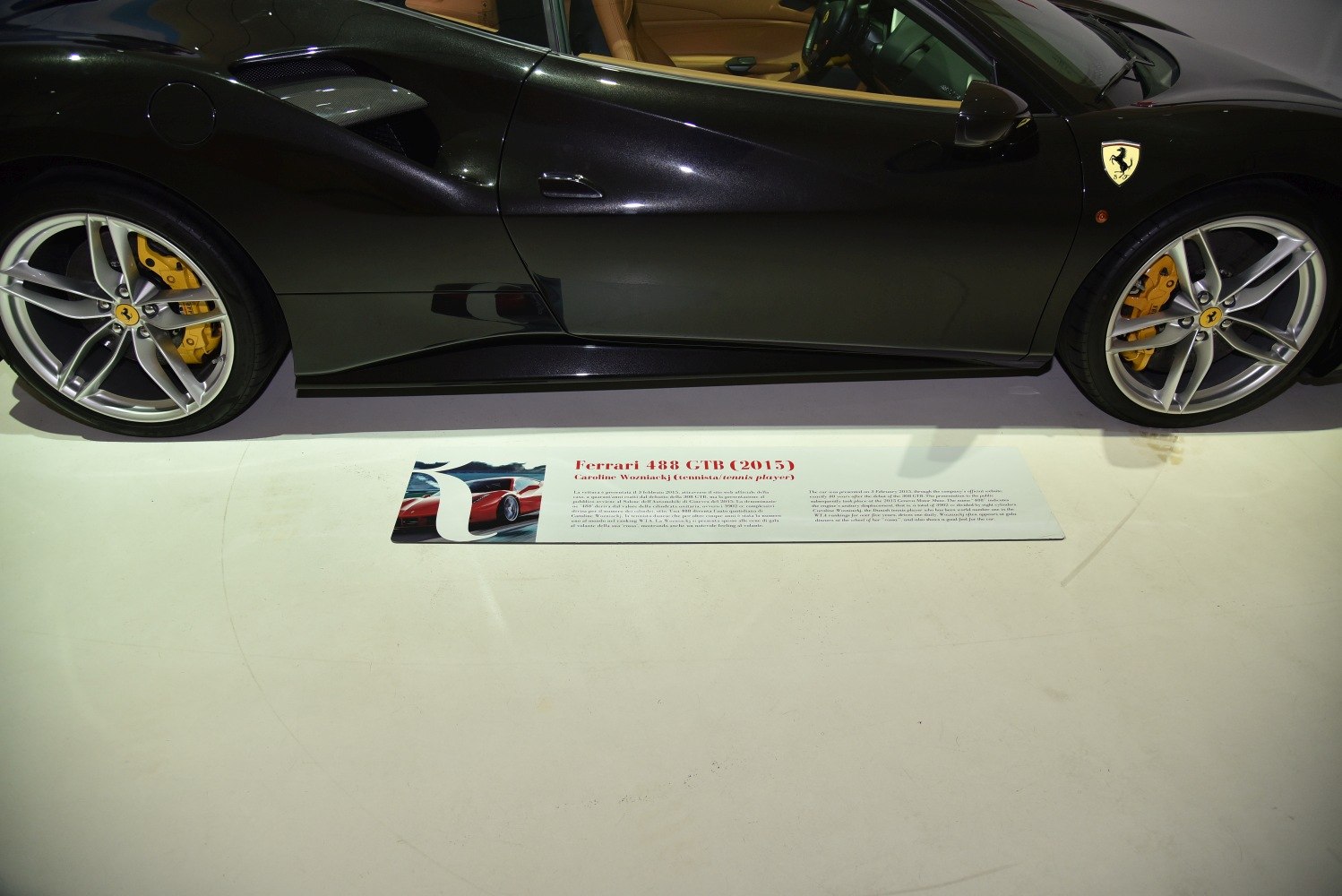 Sleek side profile and yellow brake calipers of a sports car