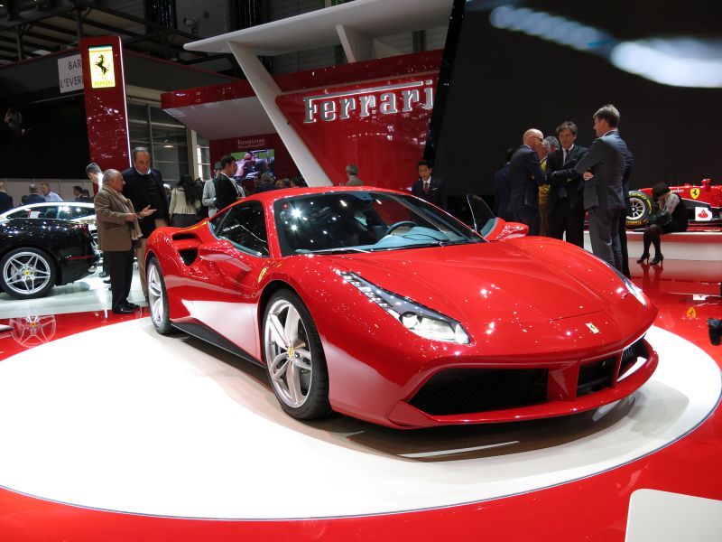 Red high-performance sports car with aerodynamic headlights and sleek front design