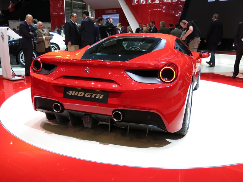 Rear view of a sports car with circular taillights and twin exhausts