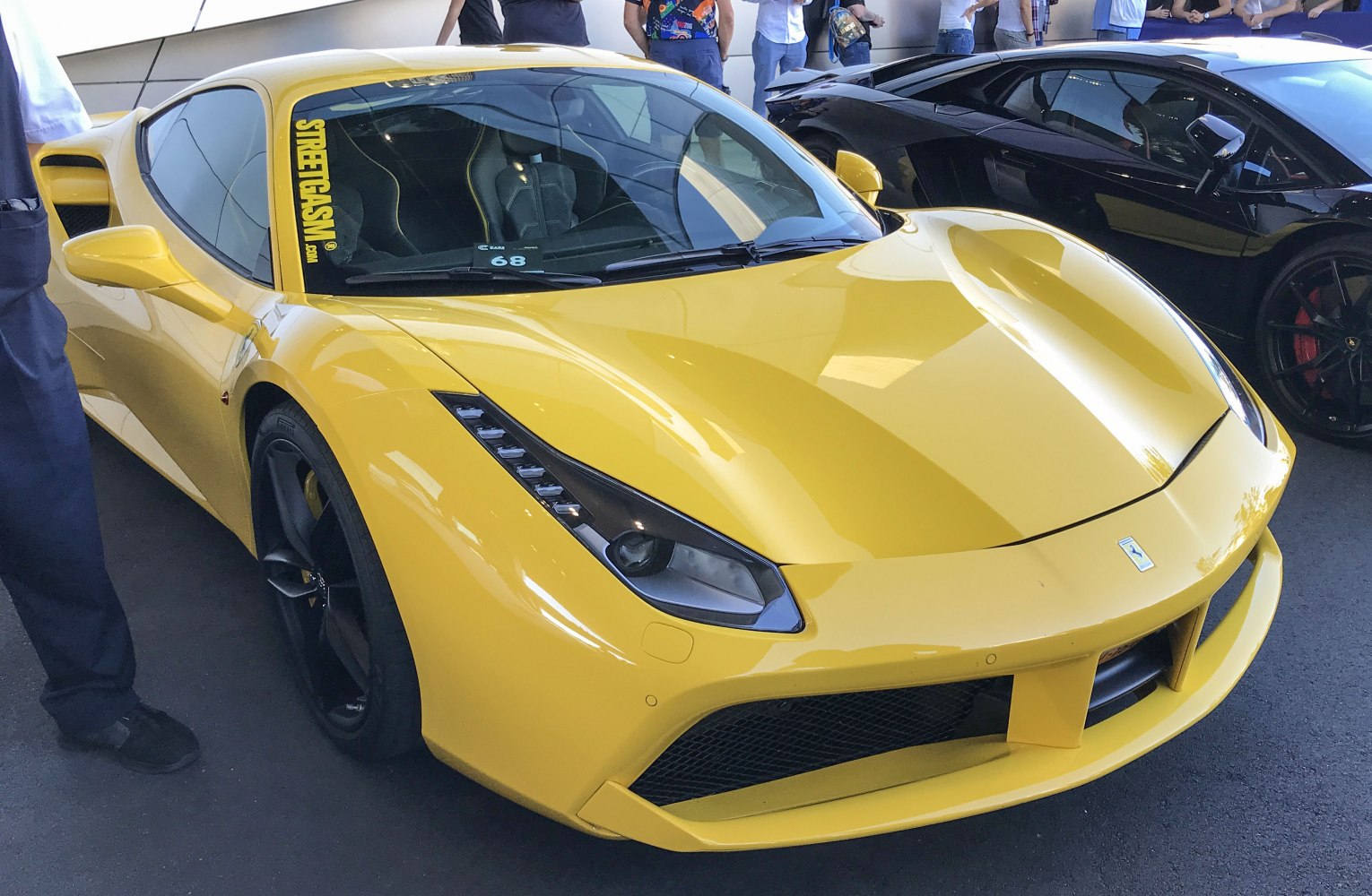 Yellow sports car front with sleek LED headlights and aerodynamic body lines