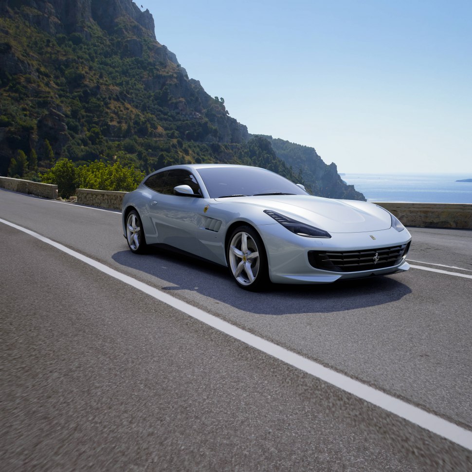 Front side view of sleek sports coupe on a mountain road