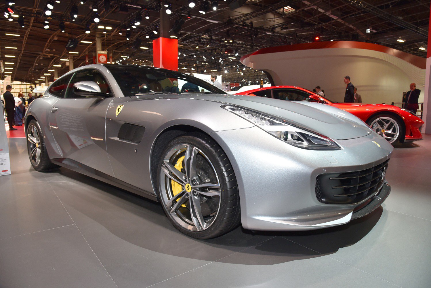 Front-side sleek headlights and alloy wheel with yellow brake caliper
