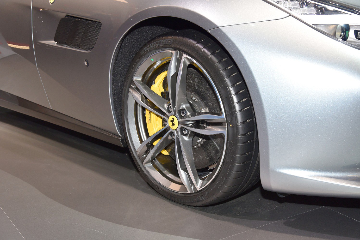 Alloy wheel with yellow brake caliper on luxury sports car